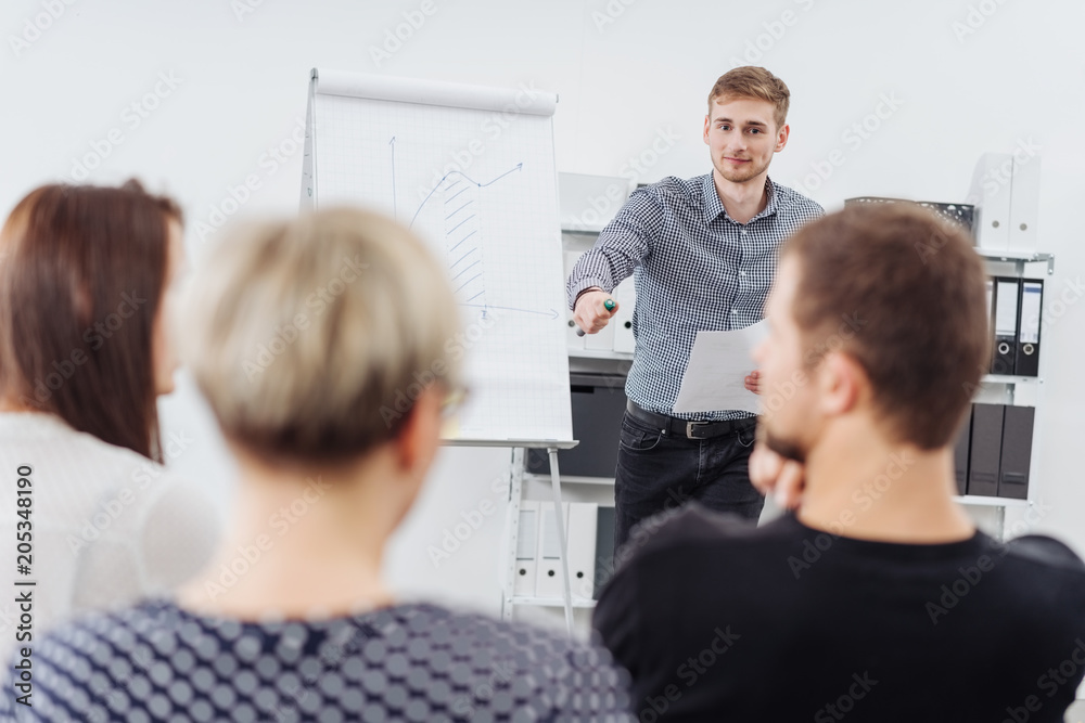 Poster Young businessman lecturing his work colleagues