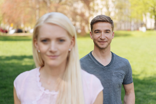 Young couple standing outdoors in an urban park