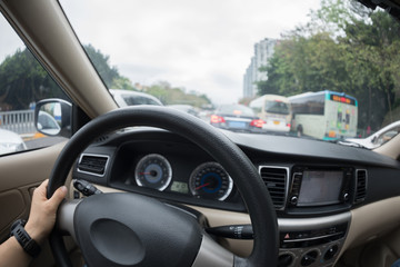 Driving car on city street in traffic jam