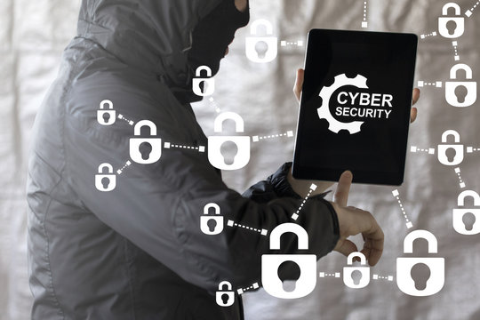 Cyber Security Hacking Digital Communication Web concept. Hacker clicks on a tablet pc with gear and cyber security words surrounded by padlock icons.