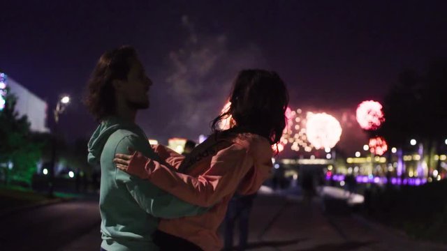 MOSCOW, RUSSIA may 2018 - Slow motion. Couple dancing on the background of fireworks in night city.