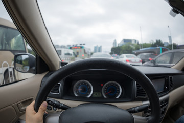 Driving car on city street in traffic jam