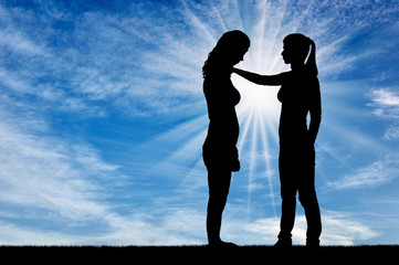 A silhouette of a woman morally supports another woman