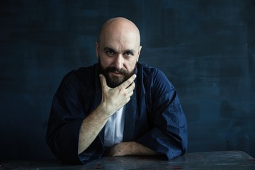 close-up portrait of stylish handsome bearded man looking at camera
