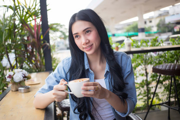 Close up of a woman taking in smell of coffee with her eyes