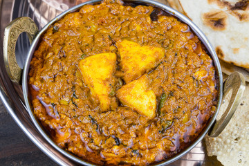 Indian Traditional Thali Food Kadai Paneer Served With Tandoori Roti or Papad on Vintage Wooden Background