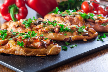 Traditional Turkish pide with meat and vegetables