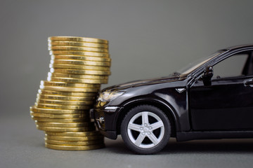 road traffic accident, car insurance concept. black car hit pile of coins