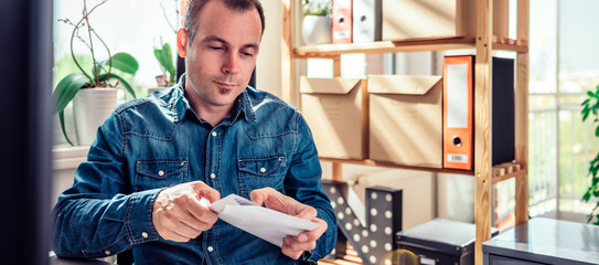 Businessman opening mail in the office