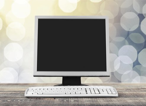 Desktop computer and keyboard on abstract background