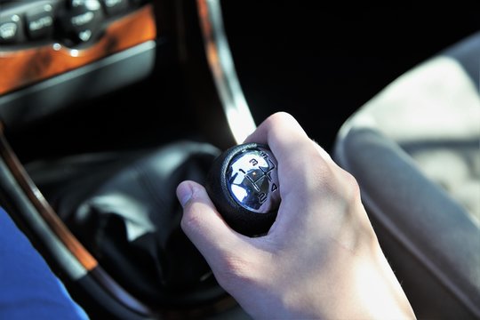 manual transmission gear shift on dark background, close-up.