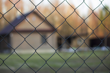 Fototapeta premium protected house behind wired fence