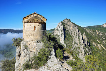 Fototapeta na wymiar Romanesque Chapel of Mare de Deu de la Pertusa over the Canelles reservoir in Lleida, Catalonia, Spain.