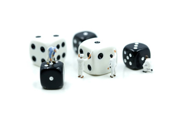 Miniature people : painter man painting a dices with paint roller