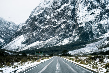 Beautiful scene of empty road to Milford sound after snow.