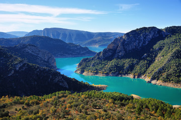 Spectacular cliff with a wooden walkway to be able to go down to a turquoise river. Montrebei Catalonia