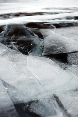 Texture of beautiful drawings on ice from cracks and bubbles of deep gas on the surface of Baikal lake in winter, Russia