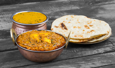 Indian Cuisine Kadai Paneer Served With Dal Makhani or Tandoori Also Know as Kadhai Paneer or Karahi Paneer is an Indian Dish of Marinated Paneer Cheese Served in a Spiced Gravy on Wooden Background