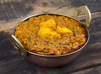 Indian Vegetarian Cuisine Kadai Paneer Also Know as Kadhai Paneer or Karahi Paneer is an Indian Dish of Marinated Paneer Cheese Served in a Spiced Gravy on Vintage Wooden Background