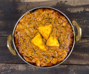 Indian Vegetarian Cuisine Kadai Paneer Also Know as Kadhai Paneer or Karahi Paneer is an Indian Dish of Marinated Paneer Cheese Served in a Spiced Gravy on Vintage Wooden Background