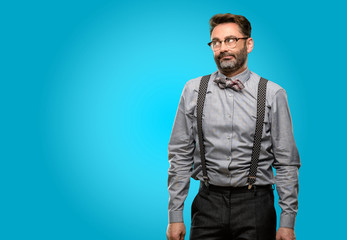 Fototapeta premium Middle age man, with beard and bow tie making funny face fooling