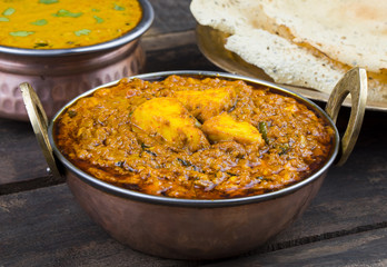 Indian Food Kadai Paneer Served With Dal Makhani or Papad Also Called Kadhai Paneer or Karahi Paneer is an Indian Dish of Marinated Paneer Cheese Served in Spiced Gravy on Wooden Background