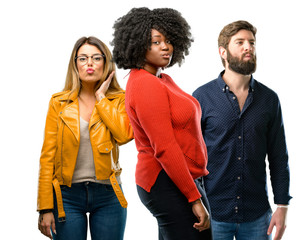 Obraz premium Group of three young men and women expressing love, blows kiss at camera, flirting