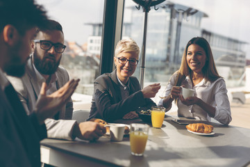 Business people having breakfast - Powered by Adobe
