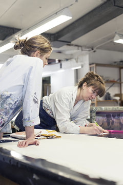 Textile designers working in workshop