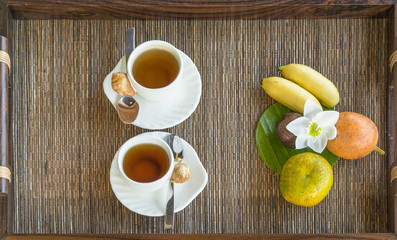 one porcelain kettle two porcelain teacup on wooden tray table top view