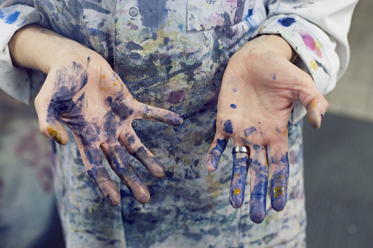 Hands covered in blue paint
