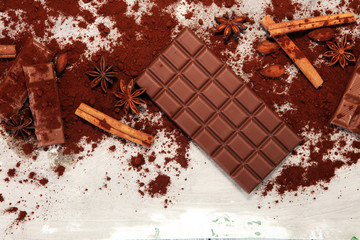Chocolate bars on table with chocolate powder.