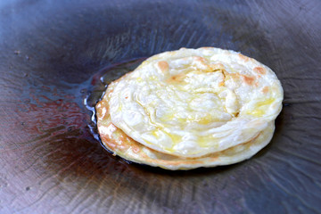 making eggs roti roll on hot metal pans with boiled vegetable oil. street food Food of Thailand