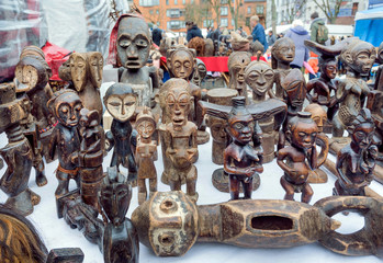 Many african totem figures of spirits for sale on flea market with antique stuff and vintage decor