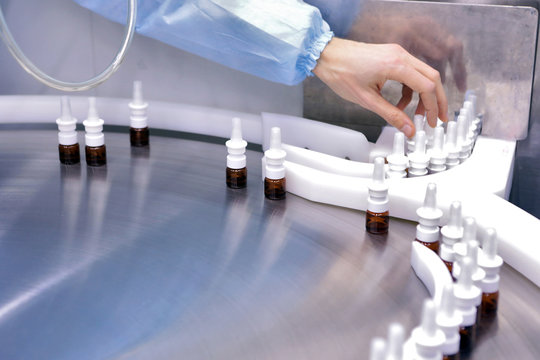 The production line of the medicine. Filling interferon in bottl