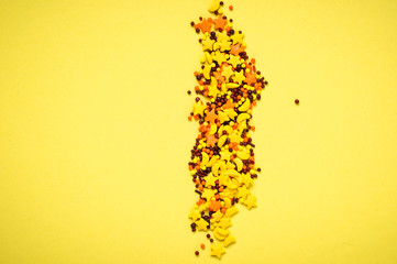 Colorful nonpareil on yellow background