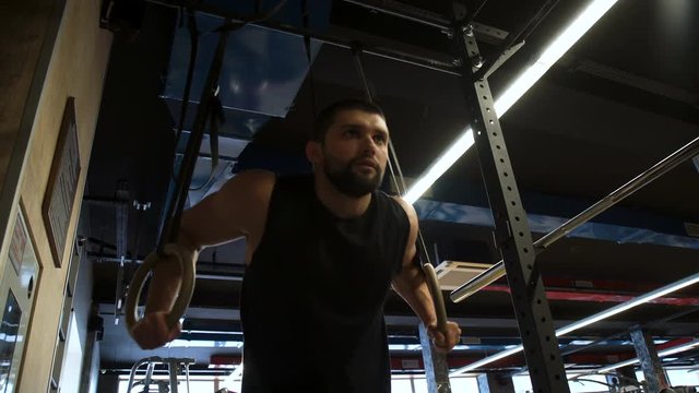 sport bodybuilding gym workout. athlete training lifestyle. health fitness strong body concept. man doing ring dips  exercise