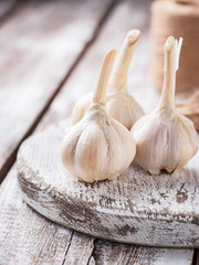 Fresh garlic on light wooden background