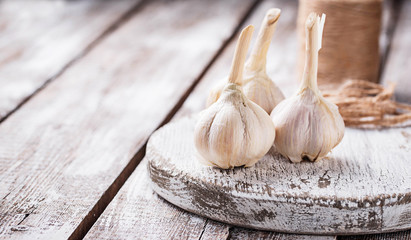 Fresh garlic on light wooden background
