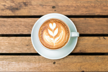 Top view of latte art coffee on wood table