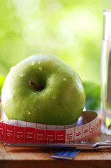 measuring tape,apple and scissors