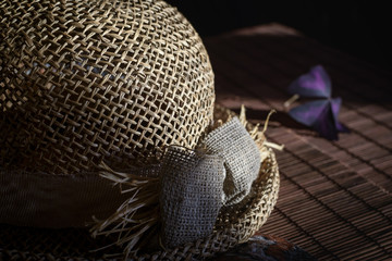 Straw hat on the bamboo tablecloth