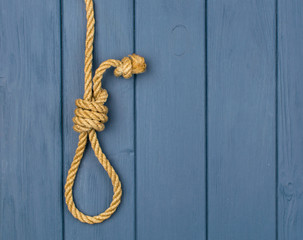 Obraz premium Hinge for the gallows on a blue wooden background.
