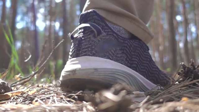 A man runs away in the forest. Slow-motion shooting of 960 frames per second