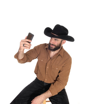 Man with cowboy hat talking a selfie