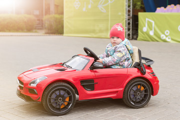 A child is riding an electric car