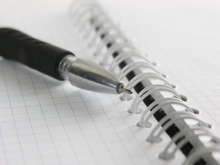 close up.ballpoint pen on open notebook background
