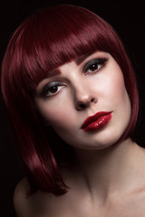 Portrait of young beautiful red-haired girl with bob haircut and stylish make-up