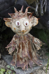 Small wooden elf in the garden as a decoration.