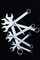 Set of chrome wrenches on black background. Car workshop concept.